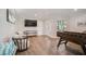 Spacious game room with wood flooring, foosball table, and outdoor access at 5708 Holmes Blvd, Holmes Beach, FL 34217