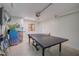 Clean garage featuring ping pong table with beach accessories and decor at 5708 Holmes Blvd, Holmes Beach, FL 34217
