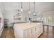 Open floor plan featuring a kitchen island with seating, stainless hardware, and wood flooring at 5708 Holmes Blvd, Holmes Beach, FL 34217