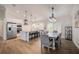 Open concept kitchen with stainless steel appliances, a large island, and an adjacent dining area for entertaining at 5708 Holmes Blvd, Holmes Beach, FL 34217