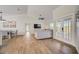 Open floorplan view of the living room and dining area featuring lots of natural light and wood flooring at 5708 Holmes Blvd, Holmes Beach, FL 34217