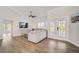 Bright living room with wood floors, a ceiling fan, and French doors to the outside patio at 5708 Holmes Blvd, Holmes Beach, FL 34217