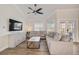 Comfortable living room with two couches, a wall-mounted TV, and lots of natural light at 5708 Holmes Blvd, Holmes Beach, FL 34217