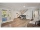 Open living area features a foosball table, staircase and natural light from the glass paneled entryway at 5708 Holmes Blvd, Holmes Beach, FL 34217