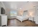 Serene main bedroom with a large window, ceiling fan, and contemporary white furnishings at 5708 Holmes Blvd, Holmes Beach, FL 34217