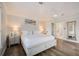 Bright main bedroom with wood floors, king bed, and ensuite bath in neutral decor at 5708 Holmes Blvd, Holmes Beach, FL 34217