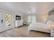Bright main bedroom features deck access, neutral decor, and a ceiling fan for added comfort at 5708 Holmes Blvd, Holmes Beach, FL 34217