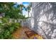 Private outdoor shower surrounded by lush tropical landscaping and stonework at 5708 Holmes Blvd, Holmes Beach, FL 34217