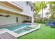 Relaxing backyard oasis with a sparkling pool, spa, and outdoor seating surrounded by lush greenery at 5708 Holmes Blvd, Holmes Beach, FL 34217