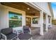 Charming porch features comfortable seating, perfect for enjoying the outdoors and elegant trim at 5708 Holmes Blvd, Holmes Beach, FL 34217
