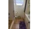 Functional bathroom with a tub, neutral tile flooring, and a sink with white cabinet at 618 51St W Ave, Bradenton, FL 34207