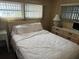 Relaxing main bedroom with a plush queen-size bed, side tables, and plenty of natural light at 618 51St W Ave, Bradenton, FL 34207