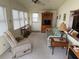 Cozy, well-lit living room featuring comfortable seating, a ceiling fan, and ample natural light at 618 51St W Ave, Bradenton, FL 34207