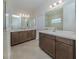 Bathroom featuring double vanities with wooden cabinets and modern fixtures at 6333 Dry Tortugas Dr, Sarasota, FL 34241