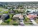 Aerial view of the property showcasing the well-maintained lawn, screened pool, and proximity to the neighborhood at 6684 Easton Dr, Sarasota, FL 34238