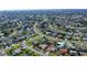Aerial view of a charming home nestled in a well-established neighborhood with lush greenery and mature trees at 6684 Easton Dr, Sarasota, FL 34238