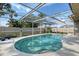 Spacious backyard showcasing lush green grass leading to a screened-in pool area, perfect for outdoor relaxation at 6684 Easton Dr, Sarasota, FL 34238
