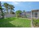 Expansive backyard featuring manicured lawns and a screened-in pool area, ideal for entertainment at 6684 Easton Dr, Sarasota, FL 34238