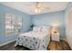 A cozy bedroom features a seaside theme with a comfortable bed and ample natural light from the window at 6684 Easton Dr, Sarasota, FL 34238