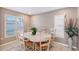 Inviting dining area with a round table, surrounded by white chairs and lit by natural light from shuttered windows at 6684 Easton Dr, Sarasota, FL 34238