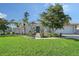Beautiful home with a well-manicured lawn, mature trees, and an inviting walkway to the front door at 6684 Easton Dr, Sarasota, FL 34238