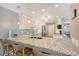 Spacious kitchen boasts a large island, granite countertops, and modern pendant lighting at 6684 Easton Dr, Sarasota, FL 34238