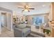 Open-concept living space with fireplace, leading to a kitchen, dining area and enclosed patio with a fountain at 6684 Easton Dr, Sarasota, FL 34238