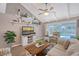 Comfortable living room featuring vaulted ceilings, ceiling fan, stylish decor, and view of the pool at 6684 Easton Dr, Sarasota, FL 34238