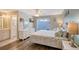 Bright bedroom with ensuite bathroom, slider access to outside and coastal accents enhance the relaxing atmosphere at 6684 Easton Dr, Sarasota, FL 34238
