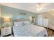 Serene bedroom featuring light blue walls, a ceiling fan, and nautical-themed decor that evokes a seaside retreat at 6684 Easton Dr, Sarasota, FL 34238