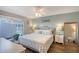 Calm main bedroom boasts a ceiling fan, slider door access to the pool and coastal decor accents at 6684 Easton Dr, Sarasota, FL 34238