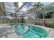 A luxurious pool is enclosed by a screen, creating a private oasis in the backyard at 6684 Easton Dr, Sarasota, FL 34238