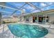 Inviting pool area featuring a screened enclosure, comfortable seating, and easy access to the home's interior at 6684 Easton Dr, Sarasota, FL 34238