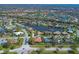 Wide aerial view of a residential neighborhood featuring well-maintained homes, lakes, and green spaces at 6900 Country Lakes Cir, Sarasota, FL 34243
