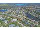 A panoramic aerial view of a beautiful community with homes surrounding lakes and lush green landscaping at 6900 Country Lakes Cir, Sarasota, FL 34243