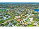 An aerial view showcases homes in a verdant Florida community, surrounded by mature trees and serene lakes at 6900 Country Lakes Cir, Sarasota, FL 34243