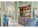 Stylish home bar with a wine fridge, mirrored shelving, and elegant decor at 6900 Country Lakes Cir, Sarasota, FL 34243