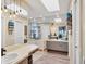 Well-lit bathroom features a large mirror, wood look floors, a bathtub, and ample storage at 6900 Country Lakes Cir, Sarasota, FL 34243