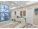 Bright bathroom with a large bathtub, stylish vanities, and ample storage space at 6900 Country Lakes Cir, Sarasota, FL 34243