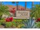 An inviting Country Lakes community entrance sign surrounded by colorful foliage and lush greenery at 6900 Country Lakes Cir, Sarasota, FL 34243
