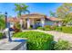 Inviting front entrance of a home with stone accents, well-manicured landscaping, and a charming brick walkway at 6900 Country Lakes Cir, Sarasota, FL 34243