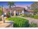 Beautiful home exterior with lush landscaping, stone pathway, and a terracotta tile roof at 6900 Country Lakes Cir, Sarasota, FL 34243