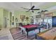 Spacious game room with a pool table, shuffleboard, and access to an outdoor area at 6900 Country Lakes Cir, Sarasota, FL 34243