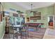 Fun game room area with a pool table, shuffleboard, and a table set, perfect for entertaining guests at 6900 Country Lakes Cir, Sarasota, FL 34243