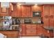 Traditional-style kitchen with granite countertops, tiled backsplash, and plenty of cabinets for storage at 6900 Country Lakes Cir, Sarasota, FL 34243