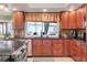 Updated kitchen with stainless steel appliances, wood cabinets, and a window overlooking the backyard at 6900 Country Lakes Cir, Sarasota, FL 34243