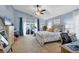 Spacious main bedroom with vaulted ceiling, slider to lanai, ceiling fan, and comfortable furnishings at 6900 Country Lakes Cir, Sarasota, FL 34243