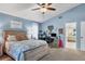 Bright main bedroom boasts vaulted ceiling, ceiling fan, plush carpet, and a tranquil coastal ambiance at 6900 Country Lakes Cir, Sarasota, FL 34243