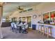 Covered outdoor dining area featuring a large table, chairs, and a bar with stool seating at 6900 Country Lakes Cir, Sarasota, FL 34243