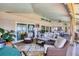 Inviting outdoor living space with a seating area, dining area, and outdoor kitchen at 6900 Country Lakes Cir, Sarasota, FL 34243